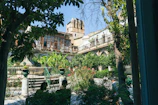 A beautiful garden courtyard surrounded by luxurious residential buildings.