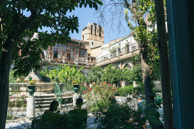 A beautiful garden courtyard surrounded by luxurious residential buildings.