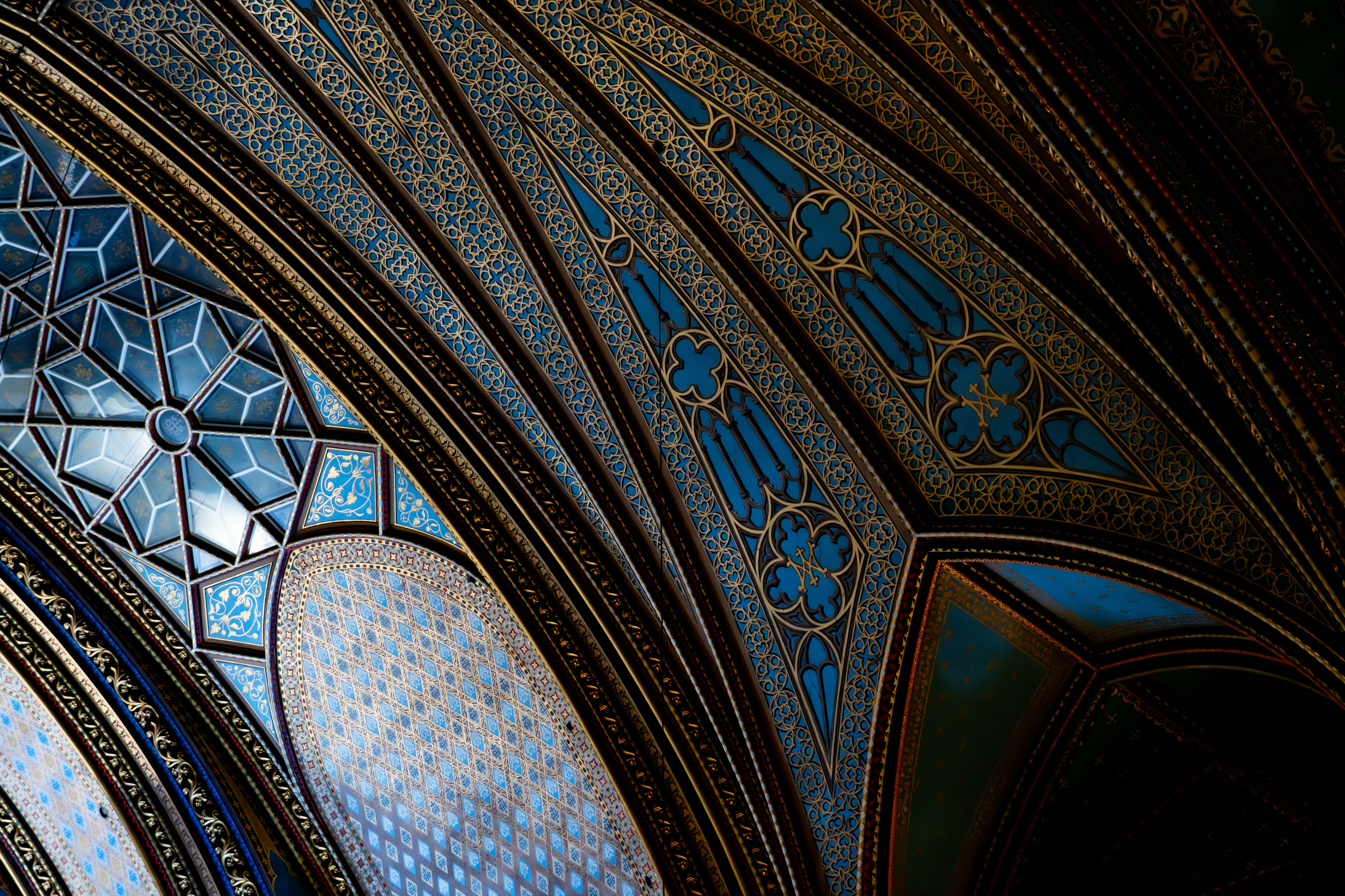 a close up of a ceiling with a clock on it
