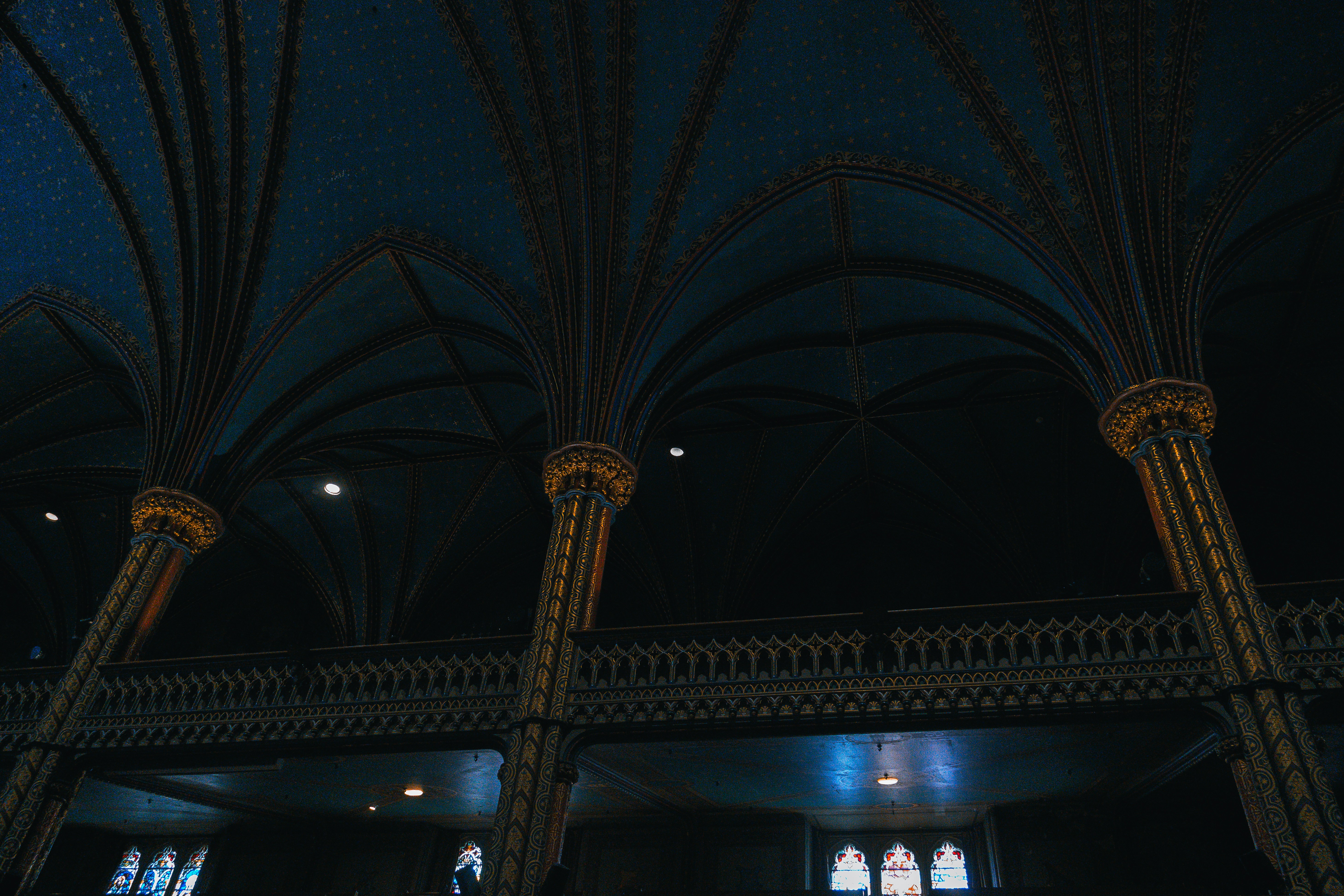 the ceiling of a building with a clock on it