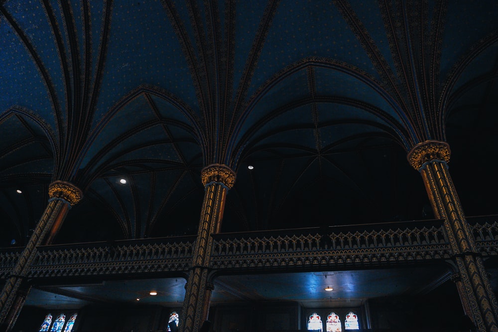 the ceiling of a building with a clock on it