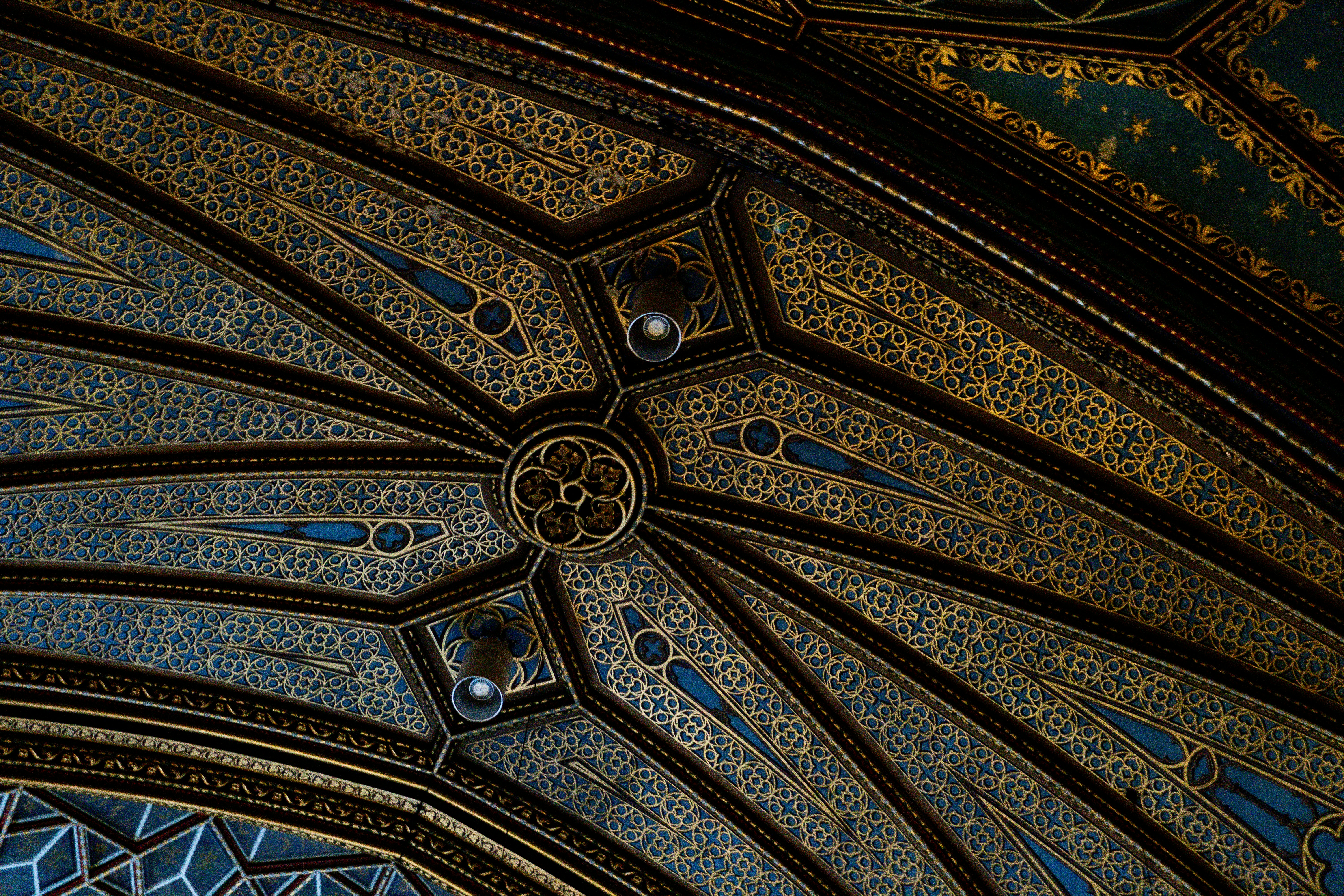 the ceiling of a building has intricate designs on it