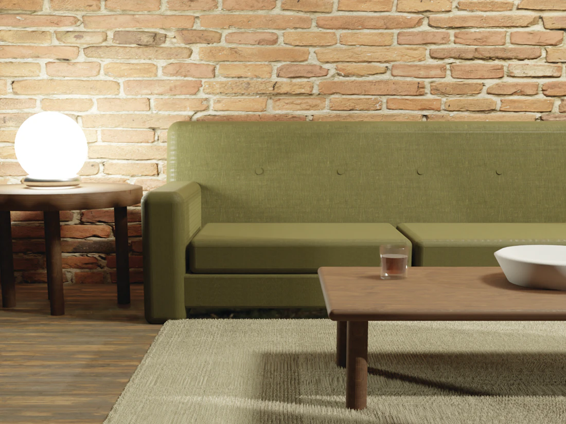 A warm sitting room with an exposed brick wall and timber floor