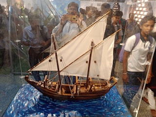 A lawyer presenting a maritime law case with a yacht model on the table