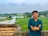 a man standing in front of a green field