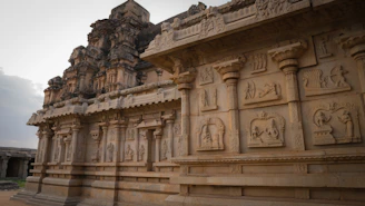 Traditional South Indian temple stones arranged artistically with intricate carvings.