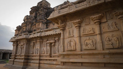 Traditional South Indian temple stones arranged artistically with intricate carvings.