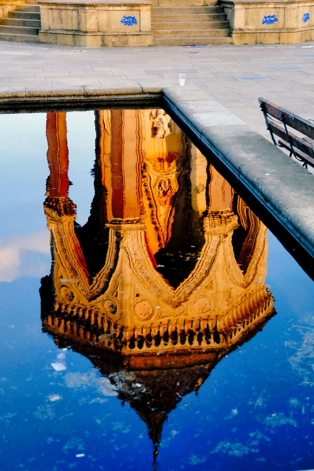 a reflection of a building in a pool of water