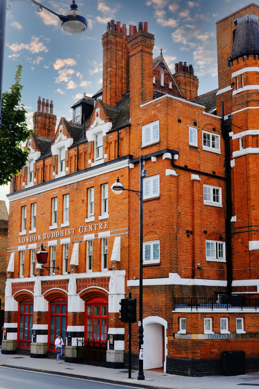 a red brick building with a street light in front of it