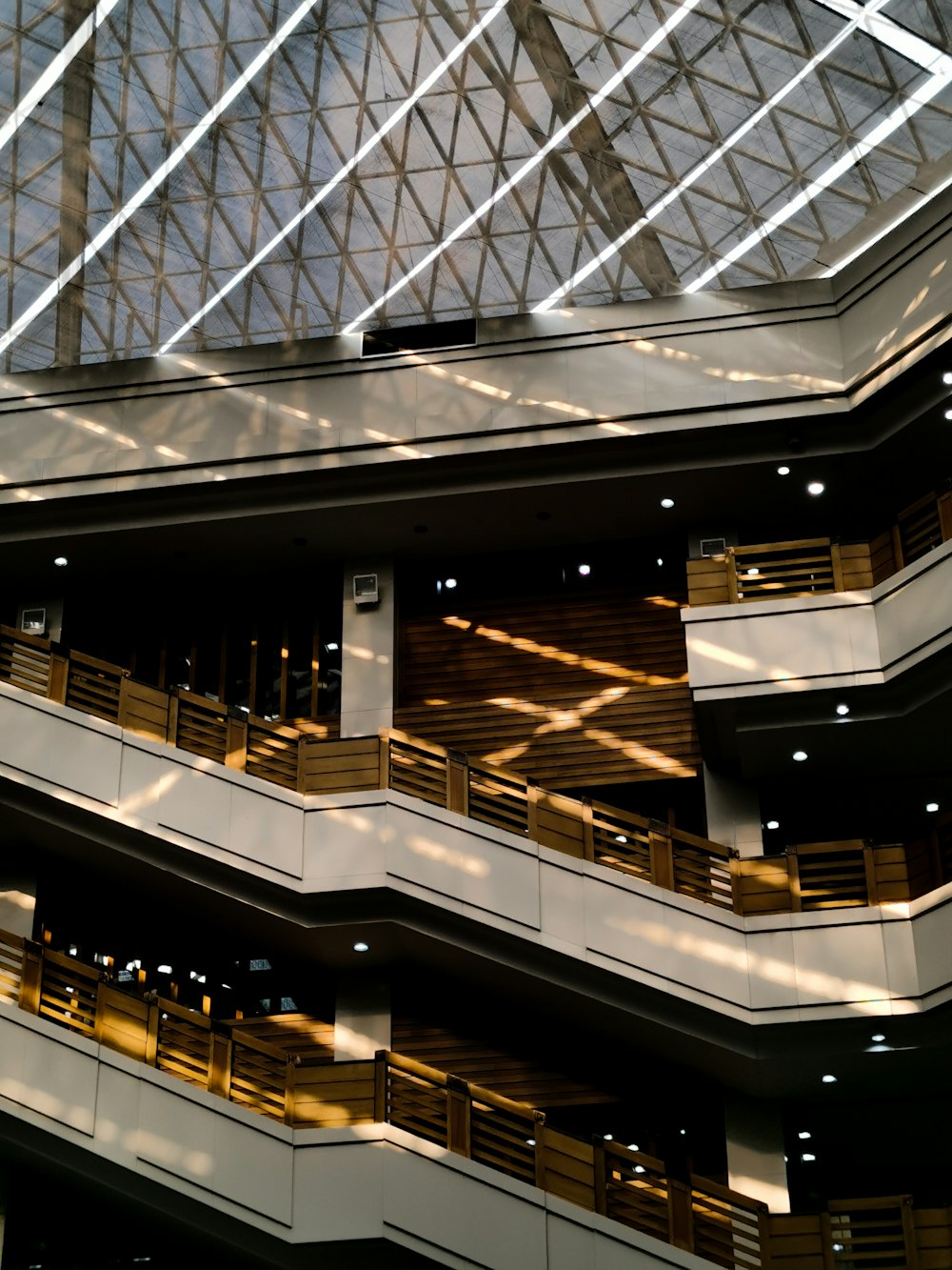 a large atrium with multiple balconies and wooden railings