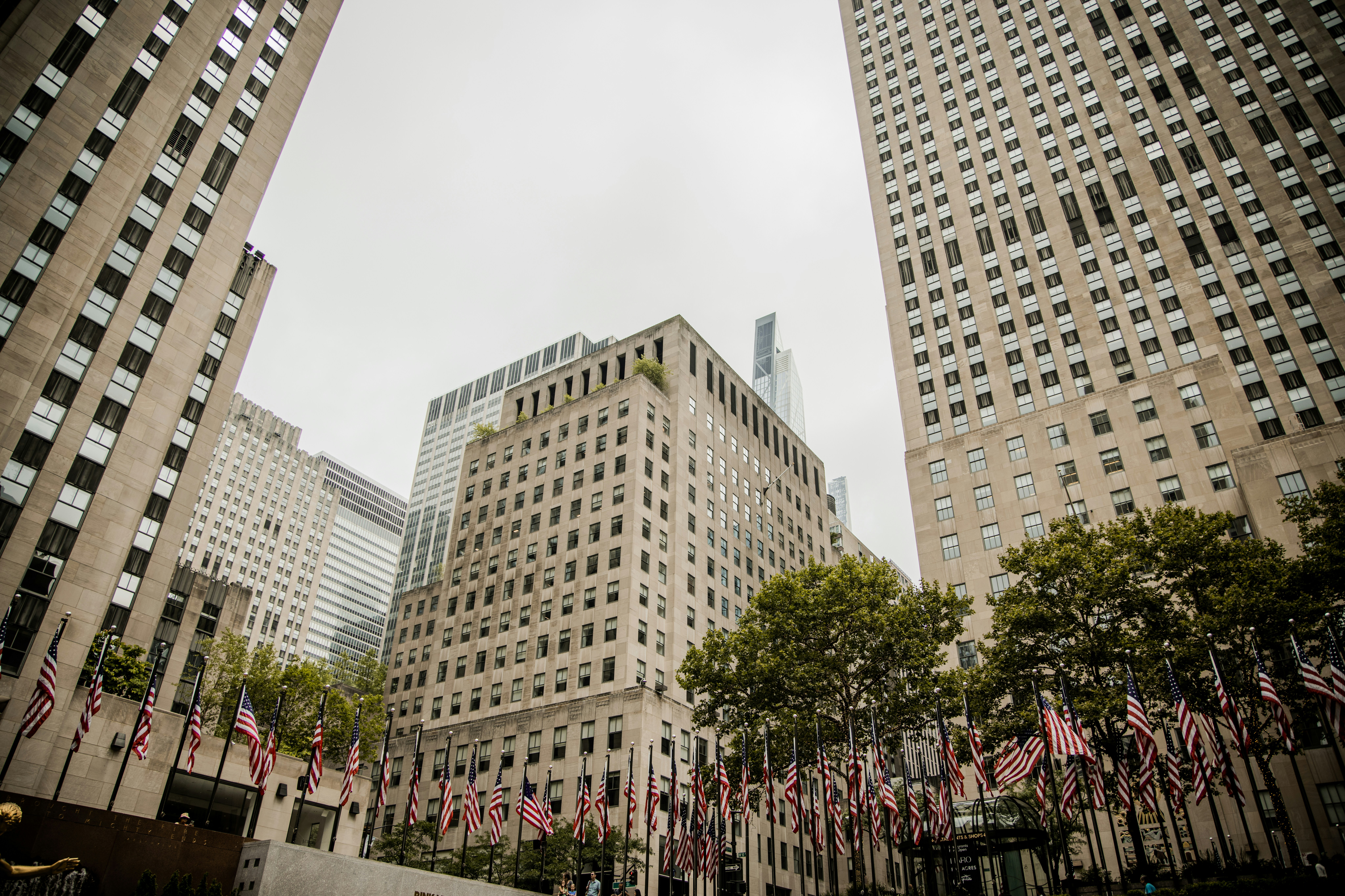 Un gruppo di edifici alti con bandiere americane in primo piano