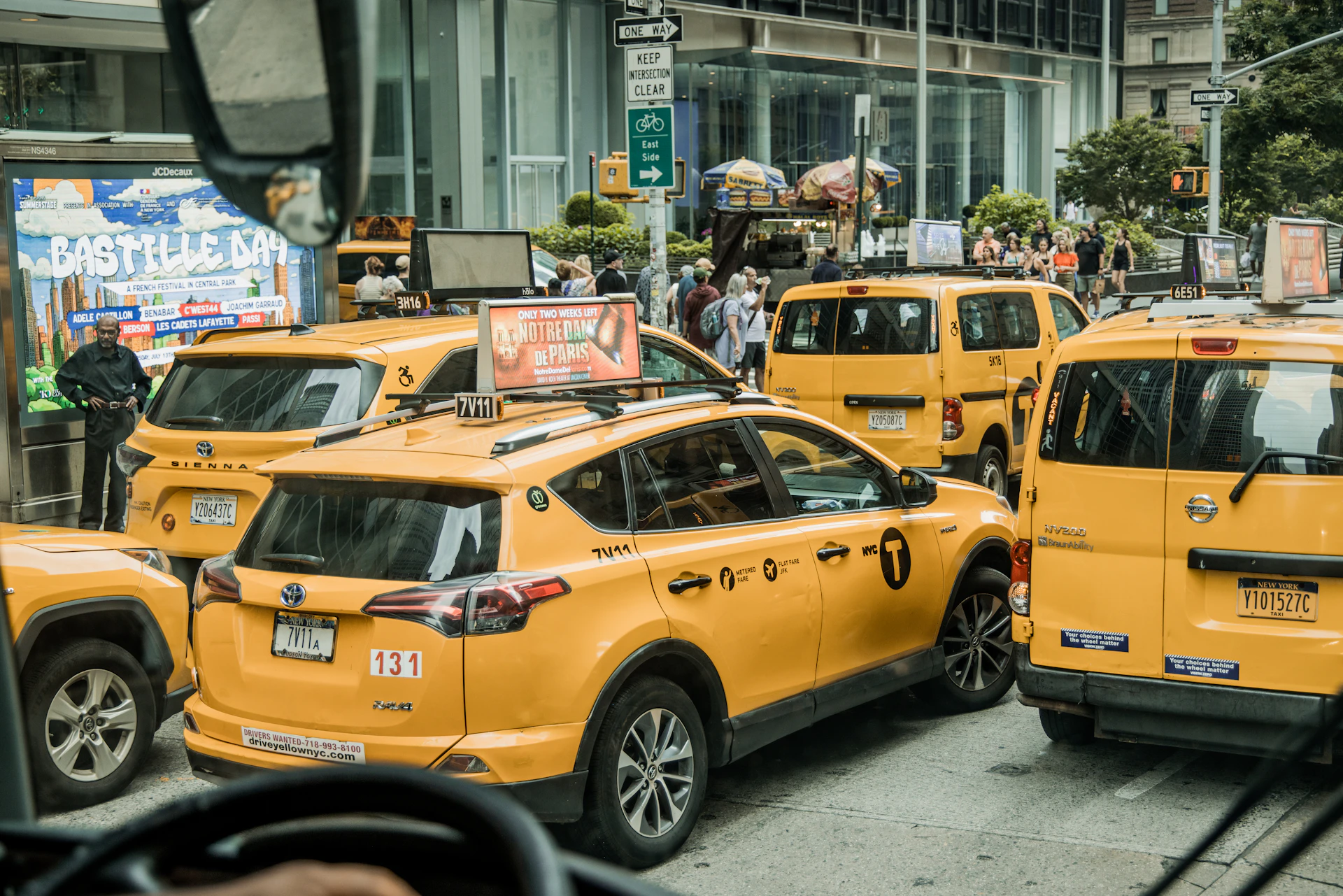 a city street filled with lots of yellow taxi cabs