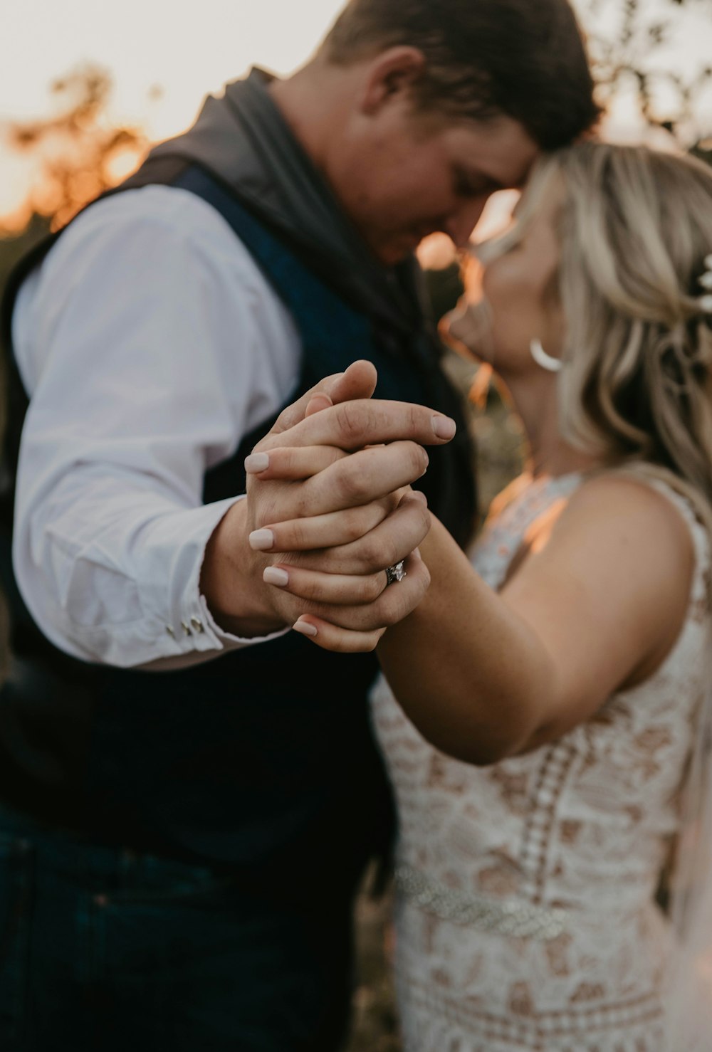 a bride and groom holding hands and smiling