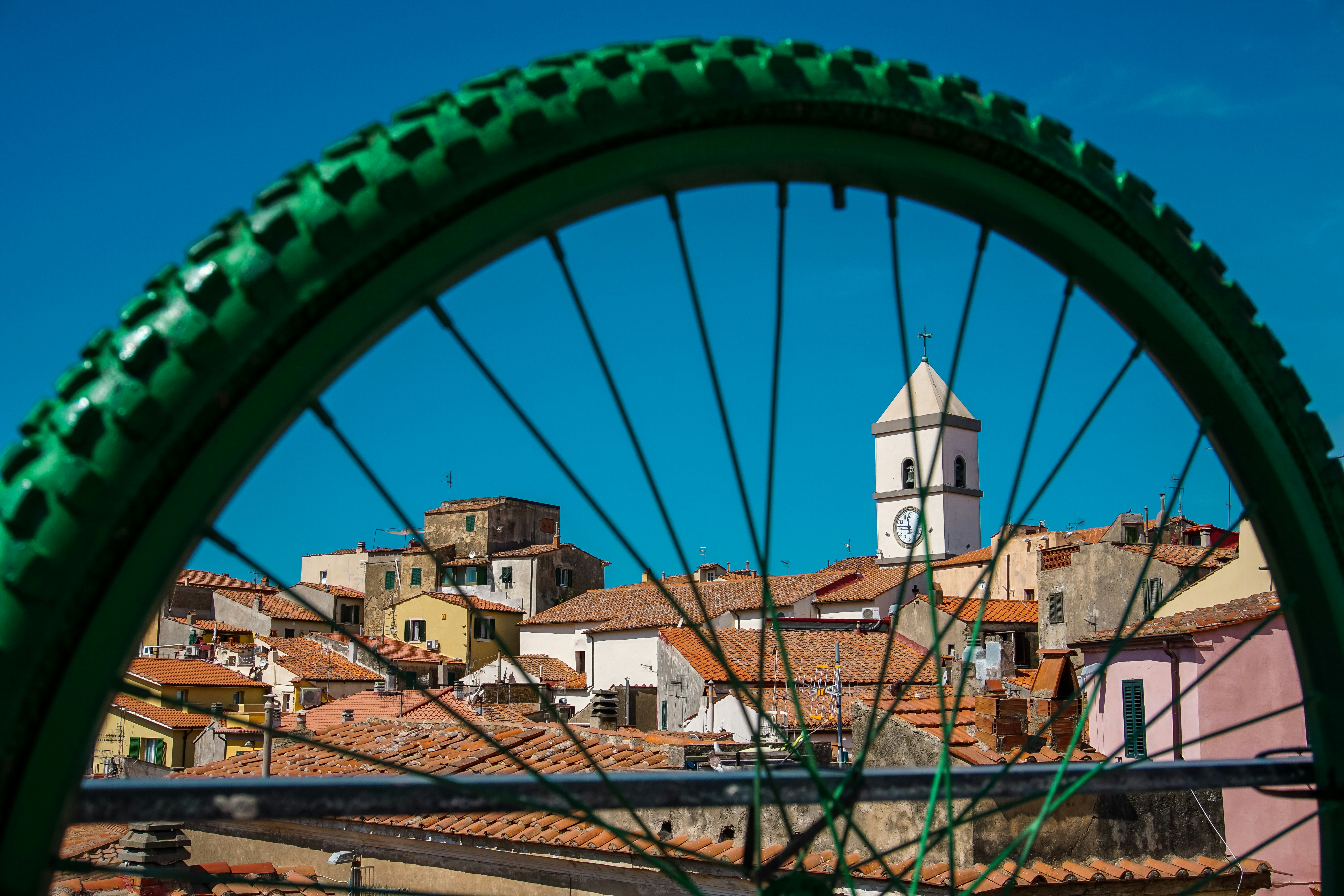 a view of a city from a bicycle wheel