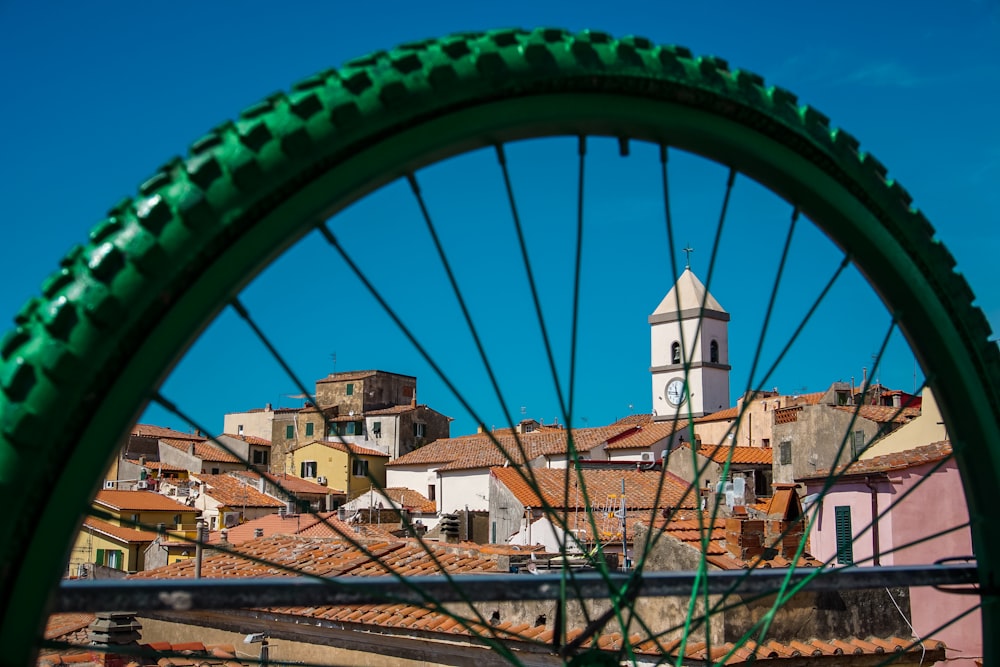 a view of a city from a bicycle wheel