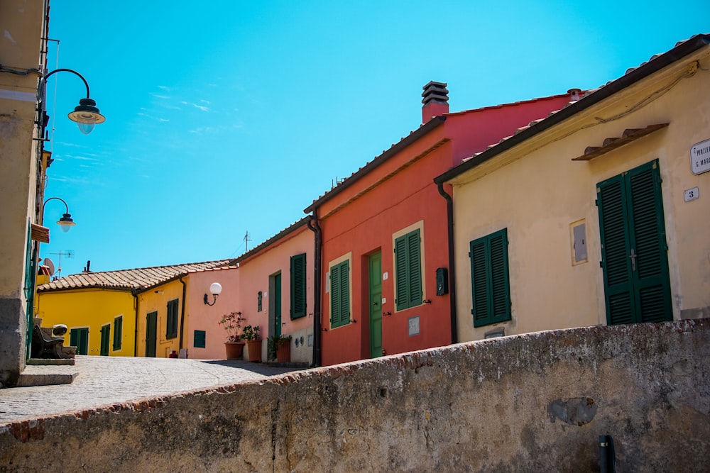 a row of colorful buildings with green shutters