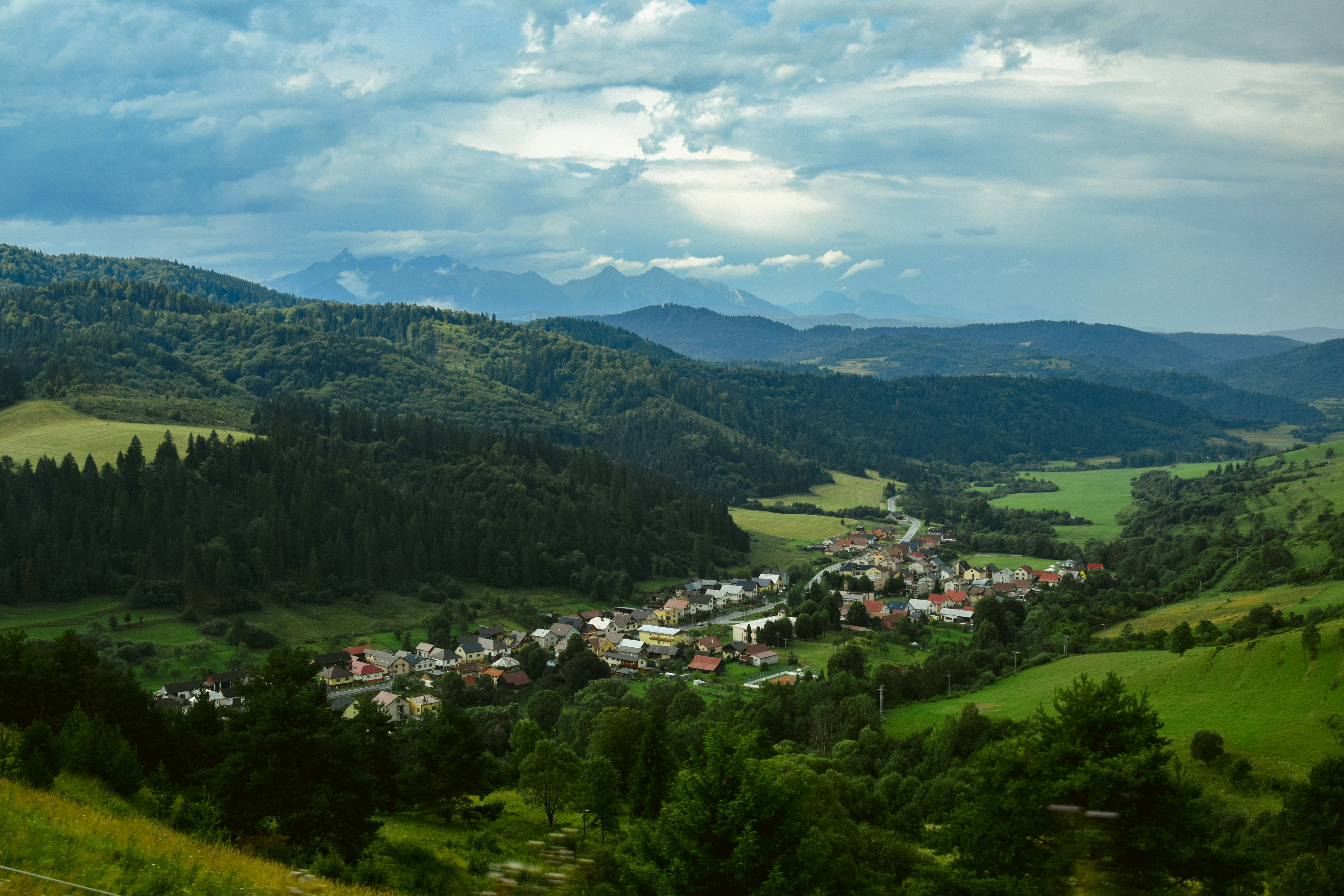 a view of a small town in the mountains