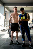 Dynamic shot of influencer and brand representative collaborating in a gym setting.