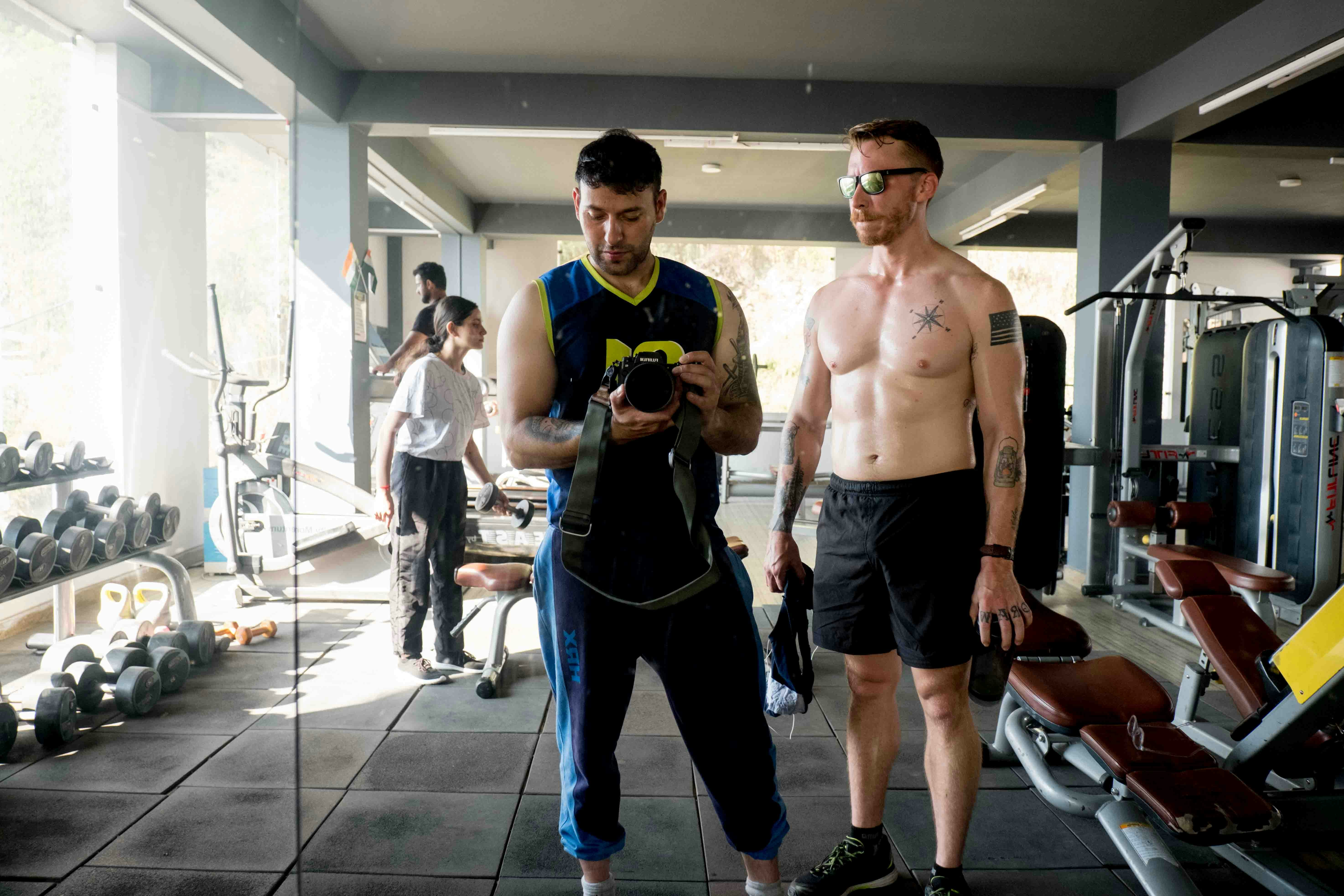 Confident gay men in gym