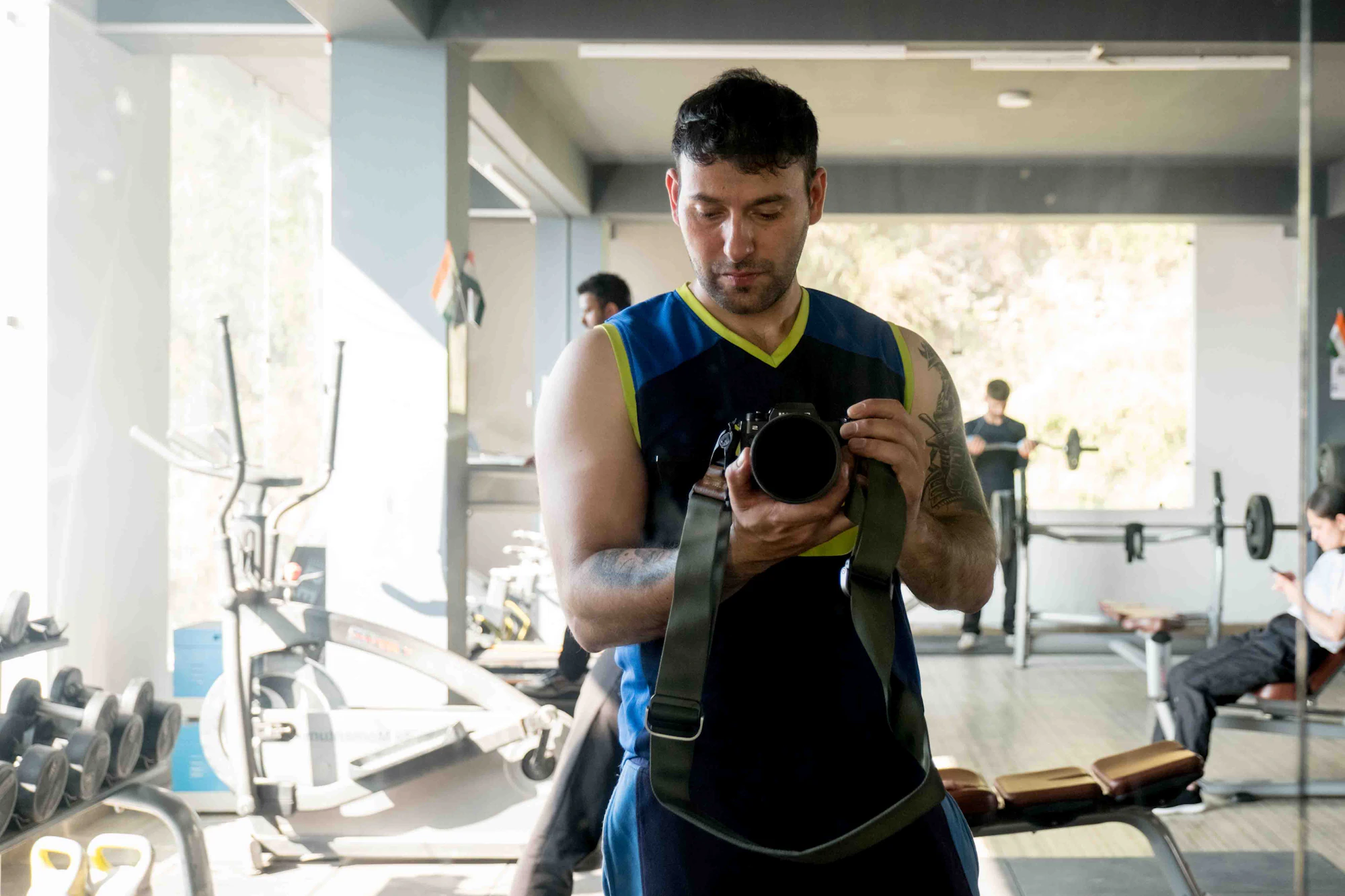 A creator holding a camera in a gym