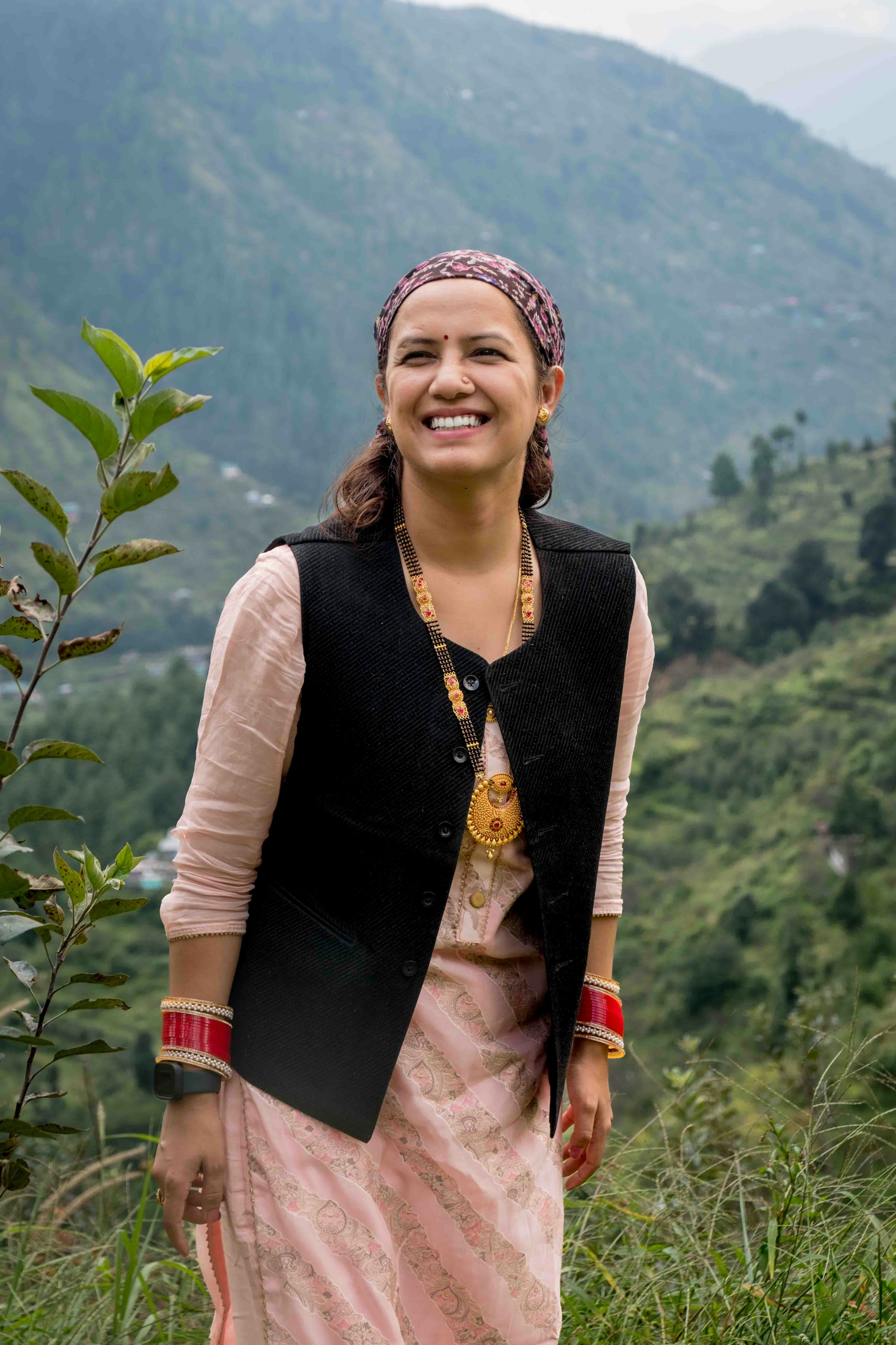 Happy guest Anita Sharma smiling after wonderful homestay experience in Uttarakhand mountains