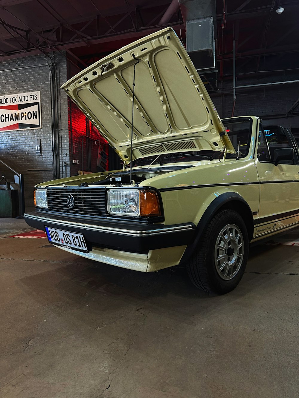 a car with its hood open in a garage