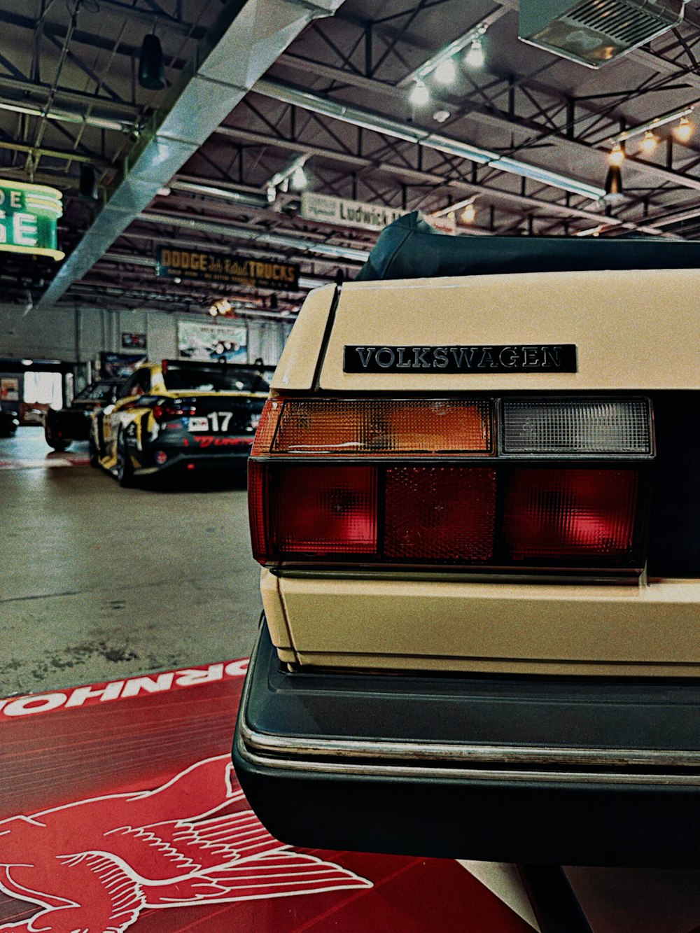 a white car parked in a garage next to other cars