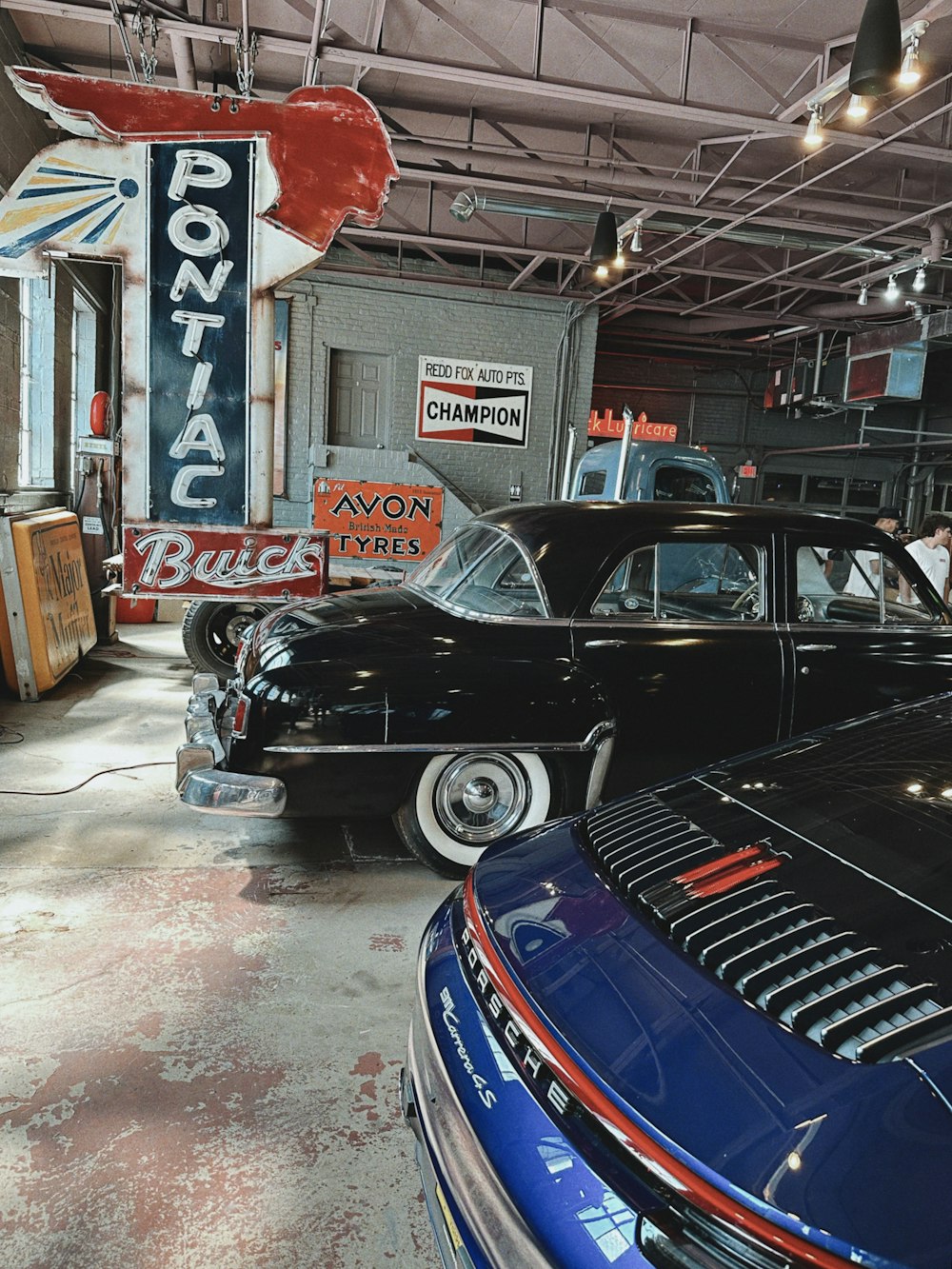 a garage filled with lots of classic cars
