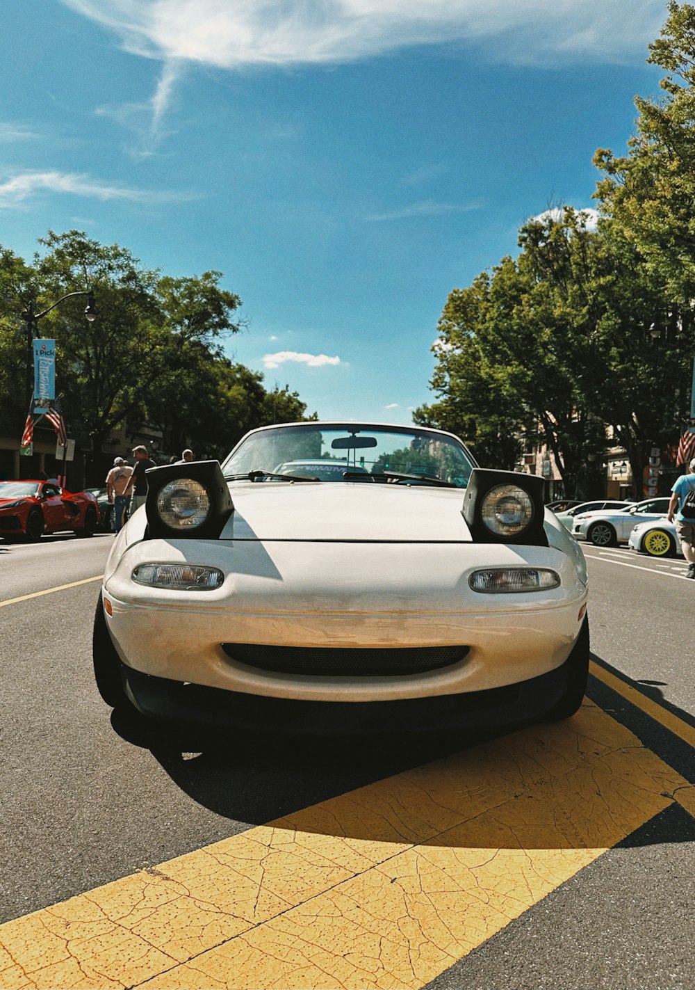 a white sports car parked on the side of the road