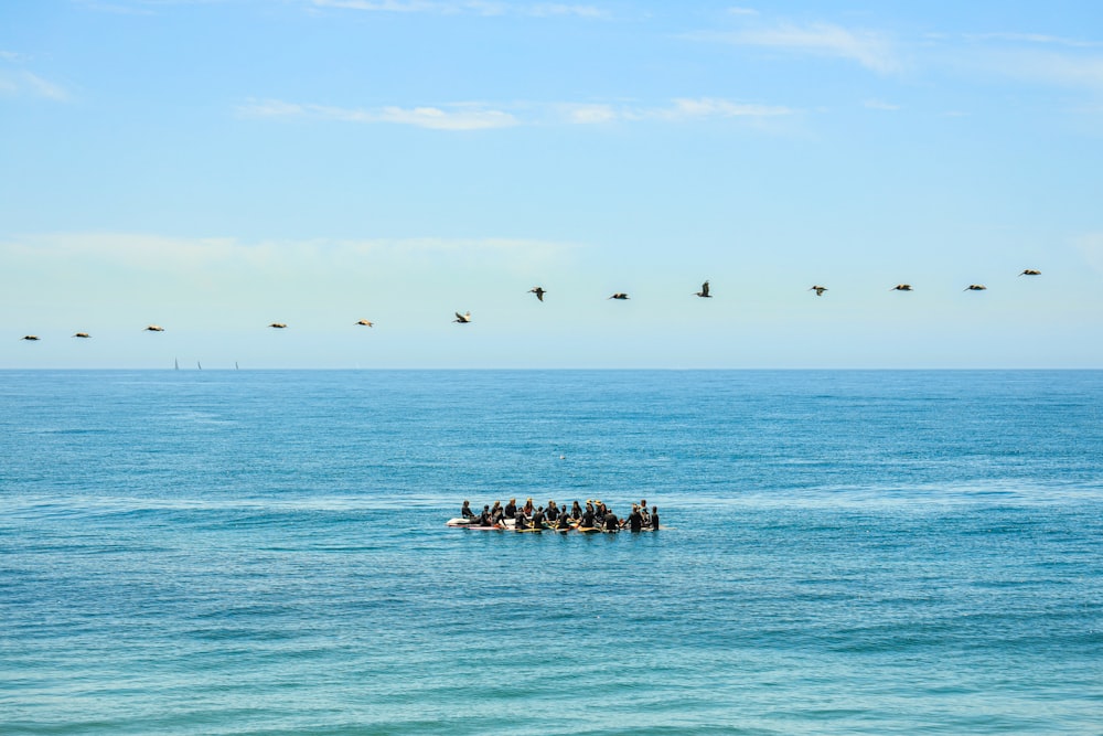 a group of people on a raft in the middle of the ocean