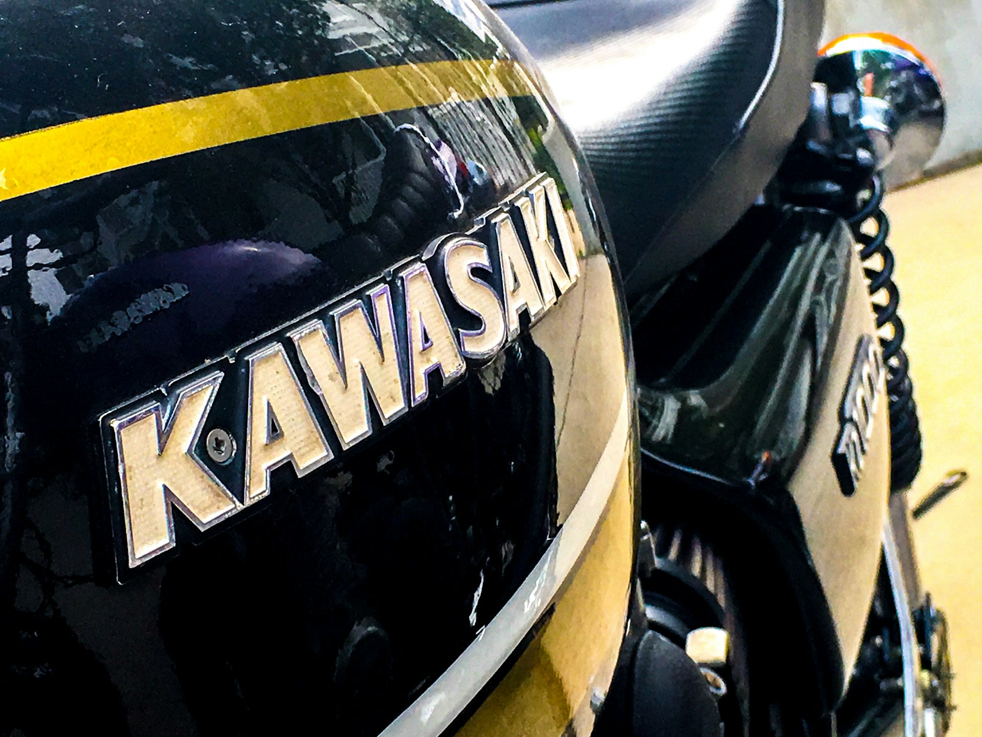 a close up of a black and yellow motorcycle
