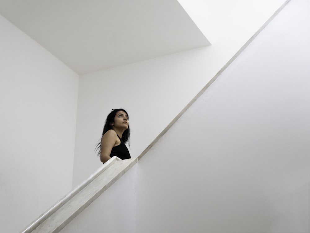 a woman is standing on the stairs of a building