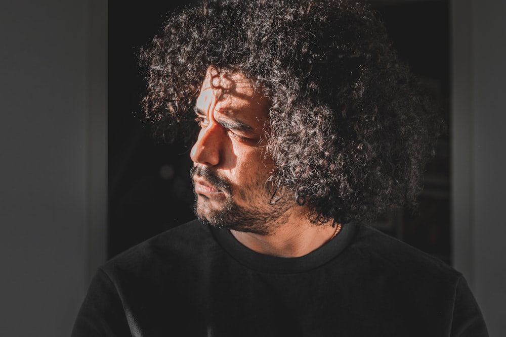 a close up of a man with curly hair