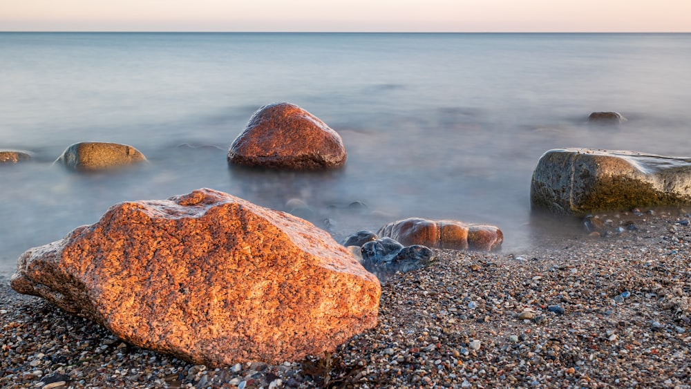 a rocky beach with large rocks in the water