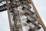 Close-up of a green-painted metal tower frame with bolts and welding details.