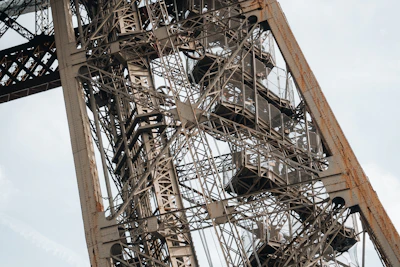 Close-up of a green-painted metal tower frame with bolts and welding details.