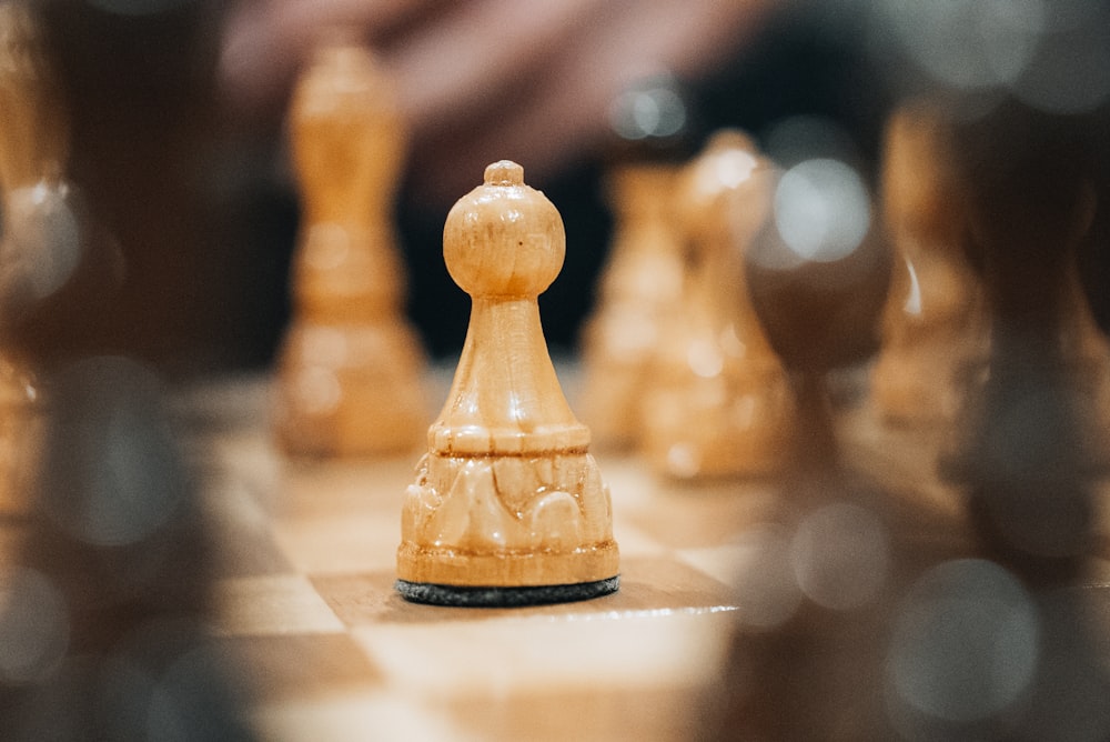 a close up of a chess board with pieces on it