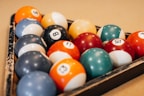 An assortment of billiard accessories including chalk and triangle racks.