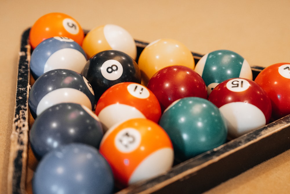 a box full of pool balls on a table