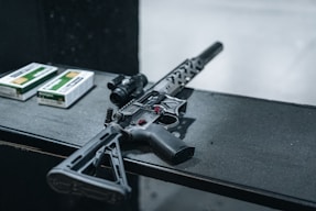 a gun and a box of cigarettes on a table