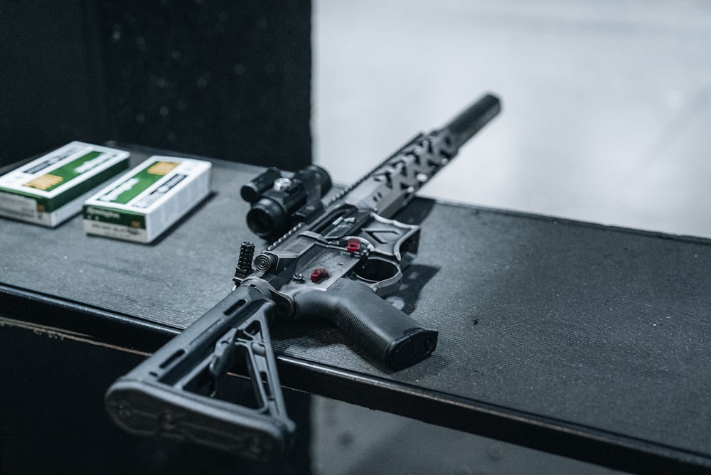 a gun and a box of cigarettes on a table