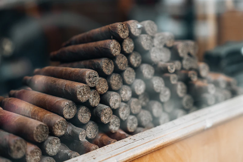 Stack of premium cigars viewed through the humidor glass