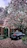 Wide shot of a smooth, newly paved driveway bordered by vibrant flower beds.