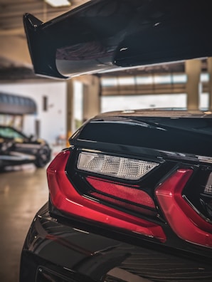 Rear view of a modified car with a factory-finish spoiler and clean lines.