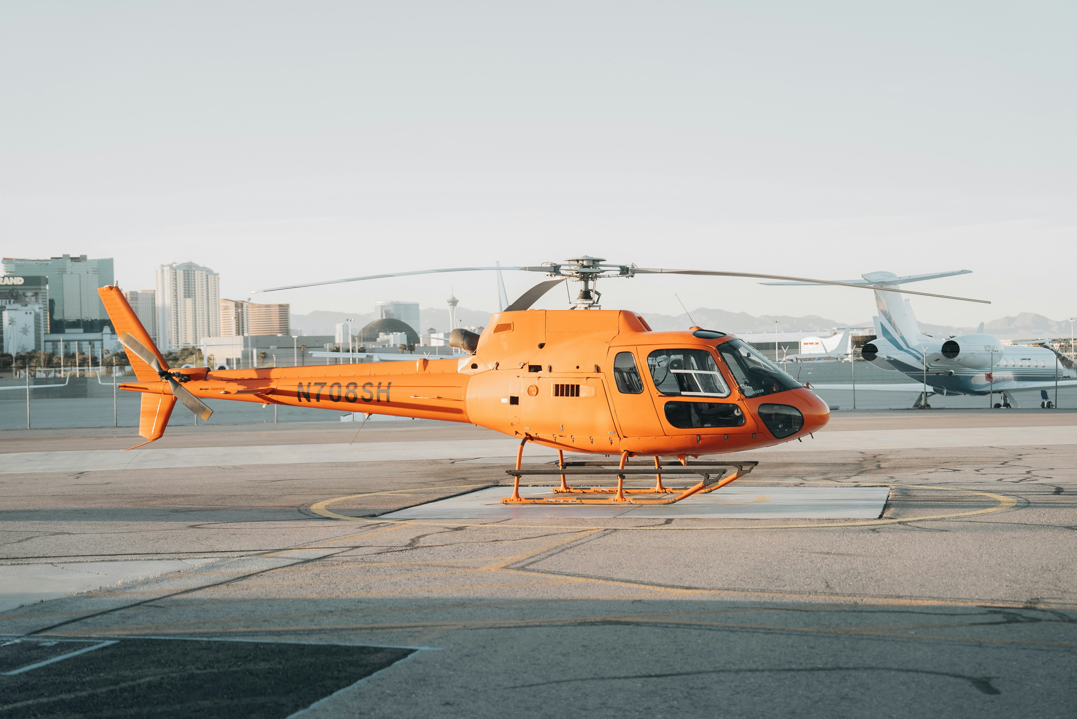 a helicopter sits on the tarmac of an airport