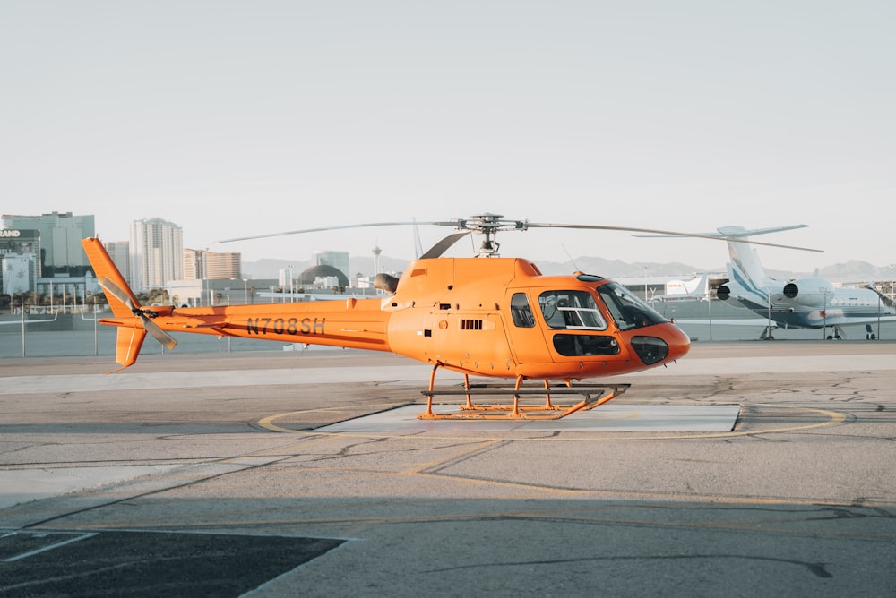 a helicopter sits on the tarmac of an airport