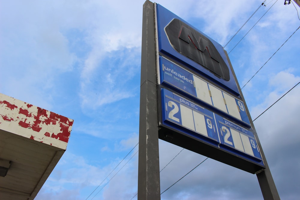 a sign for a gas station with a sky background