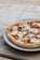 A close-up of a freshly made piadina filled with colorful ingredients on a rustic wooden table.