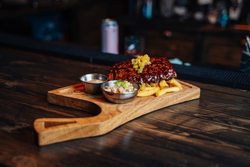 a wooden cutting board topped with a pile of food