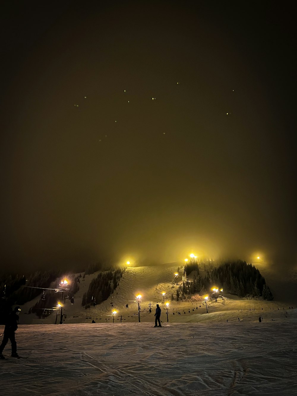 a group of people standing on top of a snow covered slope